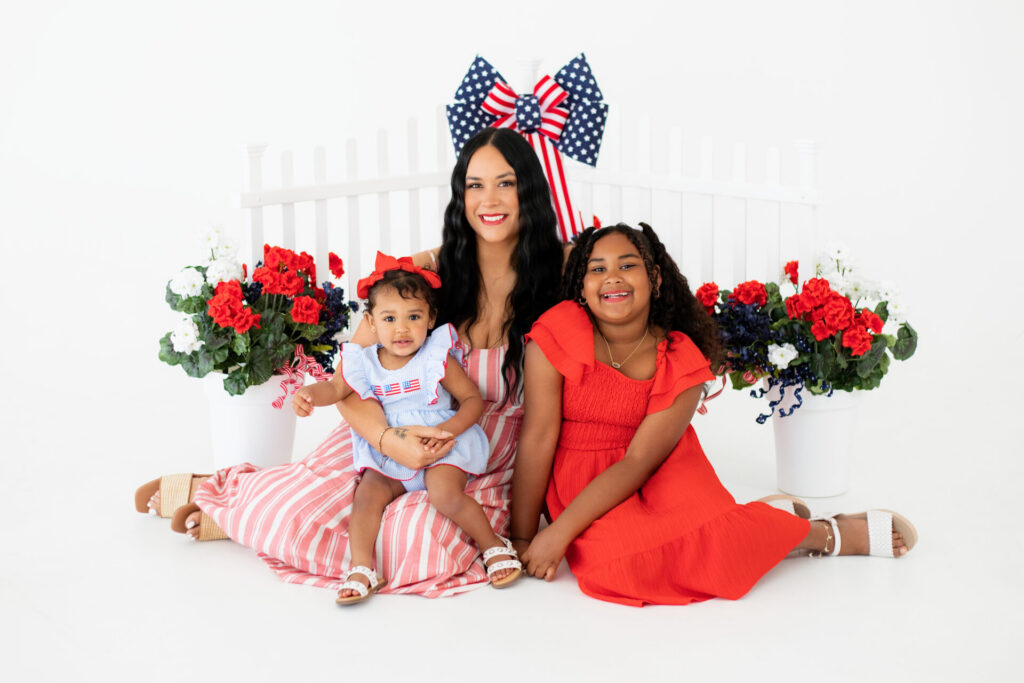 Family portrait session with patriotic summer set at Jacksonville natural light photo studio.