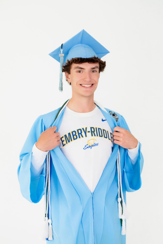 High school senior college acceptance portrait in Jacksonville, FL featuring graduate in cap and gown celebrating acceptance to Embry–Riddle Aeronautical University.