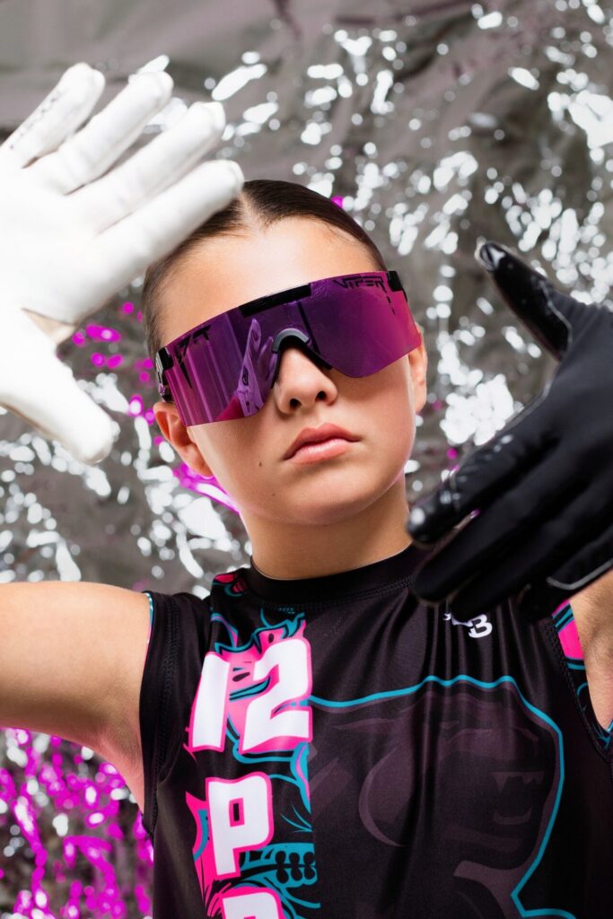 Sports photography session at Jacksonville photo studio featuring dramatic foil backdrop for athlete media day portraits.