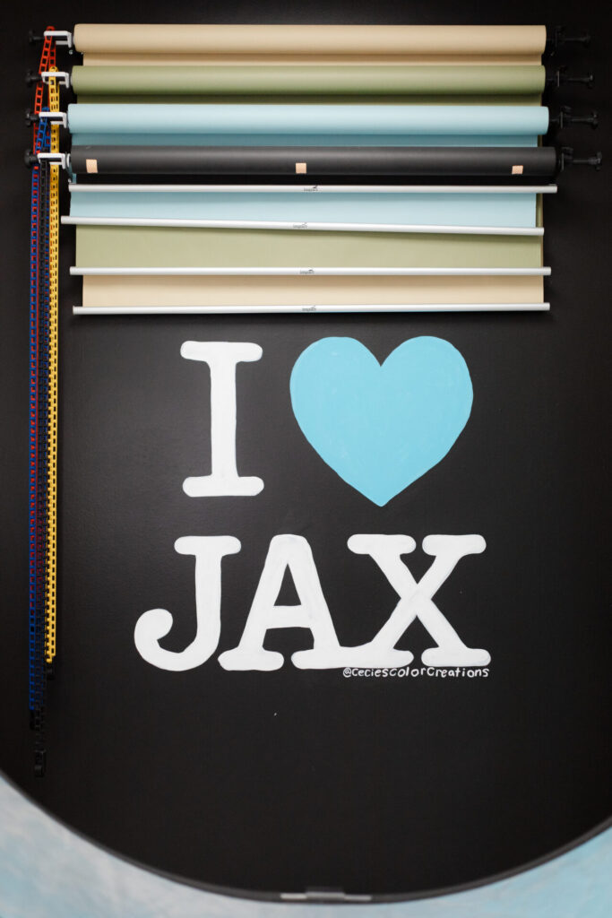 Multiple backdrop color options and I Heart Jax mural at Jax Mini Sessions Studio in Jacksonville, FL